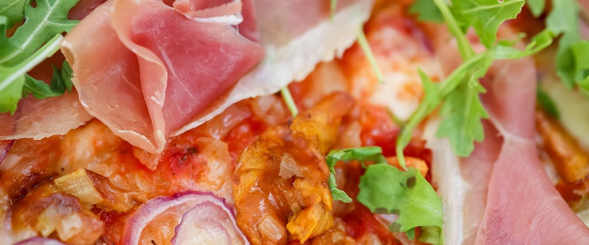 Chef preparing fusion sauce for Korean-Italian Fusion Food Trends in a modern kitchen